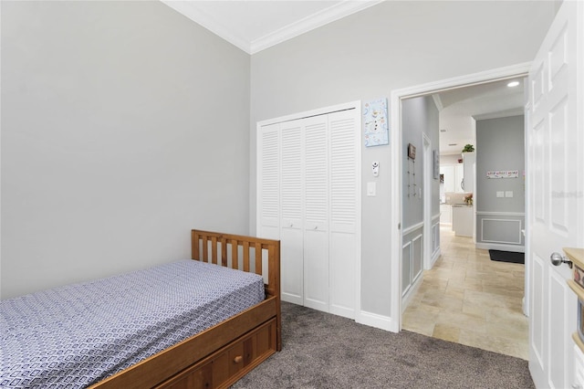 bedroom with ornamental molding, light carpet, and a closet