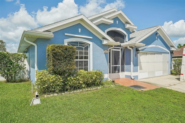 view of front of home with a garage, a front lawn, and a sunroom