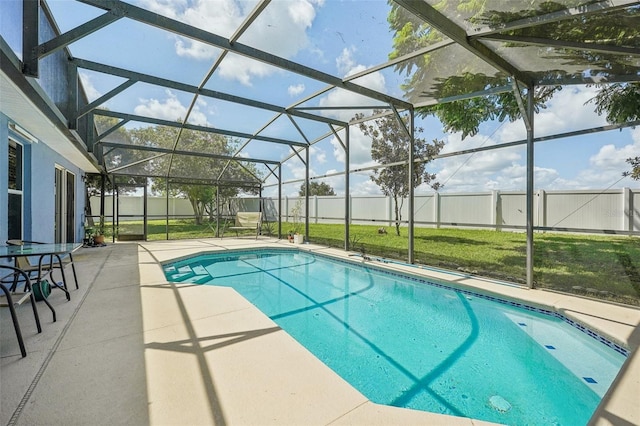 view of swimming pool with a patio, a lawn, and a lanai