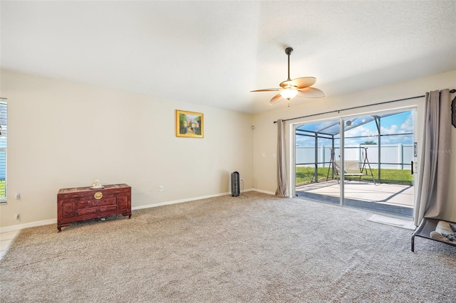 carpeted spare room with ceiling fan