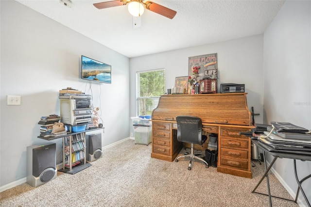 carpeted office space featuring ceiling fan and a textured ceiling