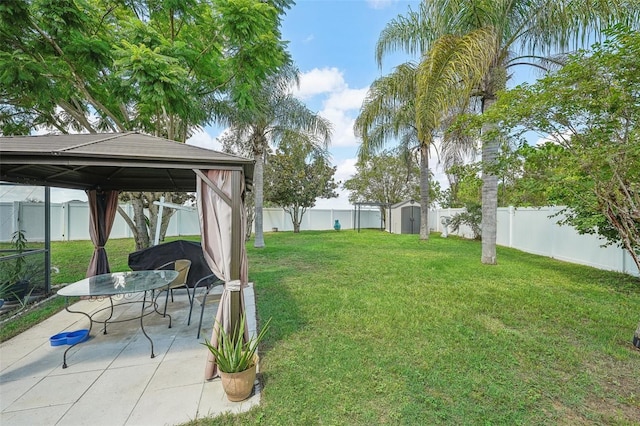 view of yard featuring a patio, a gazebo, and a storage shed