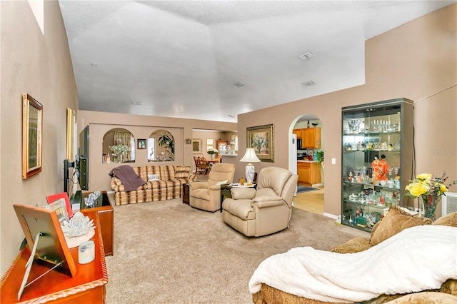 living room with light carpet and vaulted ceiling