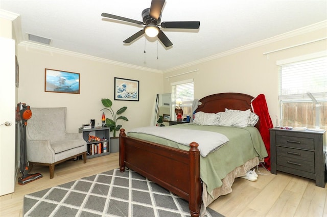 bedroom with ornamental molding, wood-type flooring, and ceiling fan