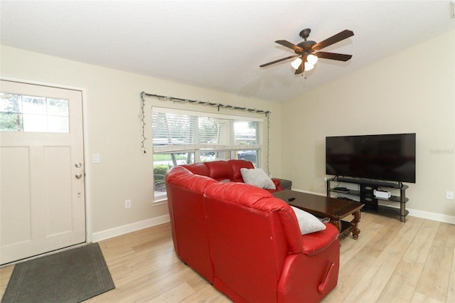 living room with light wood-type flooring, ceiling fan, and vaulted ceiling