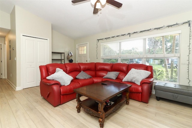 living room featuring lofted ceiling, light hardwood / wood-style flooring, and ceiling fan