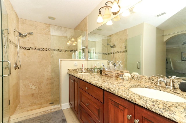 bathroom featuring tile patterned flooring, an enclosed shower, a notable chandelier, and vanity