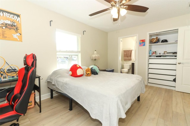 bedroom with ceiling fan, connected bathroom, and light hardwood / wood-style flooring