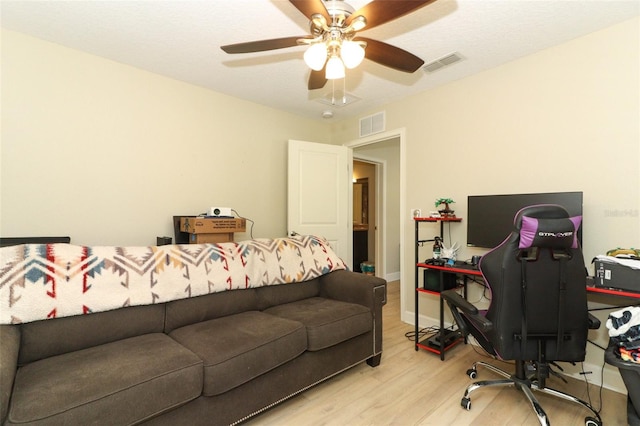 office with light wood-type flooring, a textured ceiling, and ceiling fan