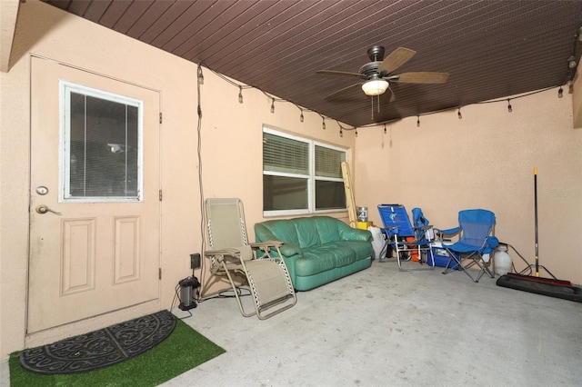 entrance to property featuring ceiling fan and a patio