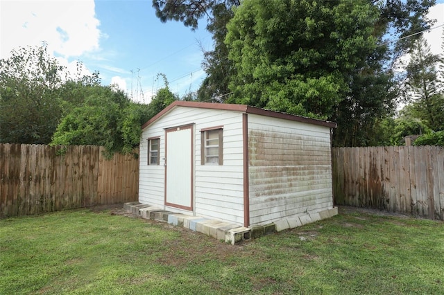 view of outbuilding with a yard