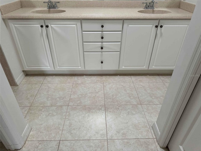 bathroom featuring tile patterned flooring and vanity