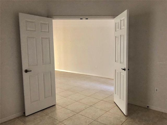 corridor with light tile patterned flooring