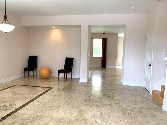 spare room with baseboards and marble finish floor