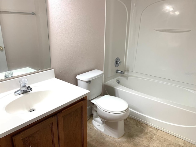 bathroom featuring toilet, vanity, shower / bathtub combination, and a textured wall