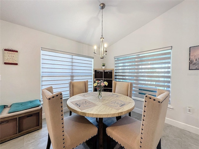 tiled dining room with vaulted ceiling, a wealth of natural light, and a notable chandelier