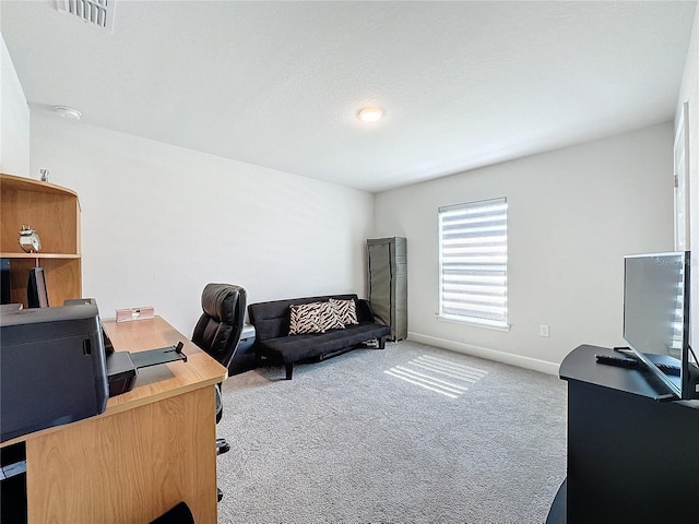 carpeted home office with a textured ceiling