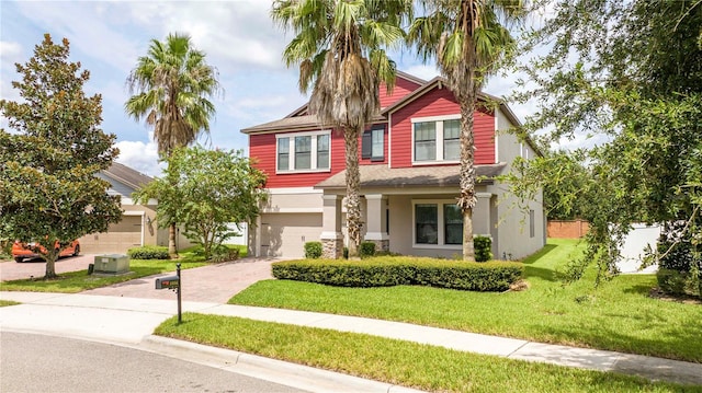 craftsman house with a garage and a front yard