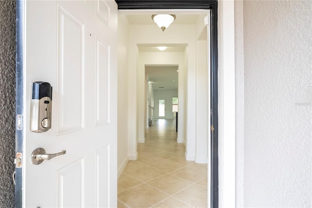 hall featuring light tile patterned floors