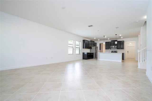 unfurnished living room featuring light tile patterned flooring