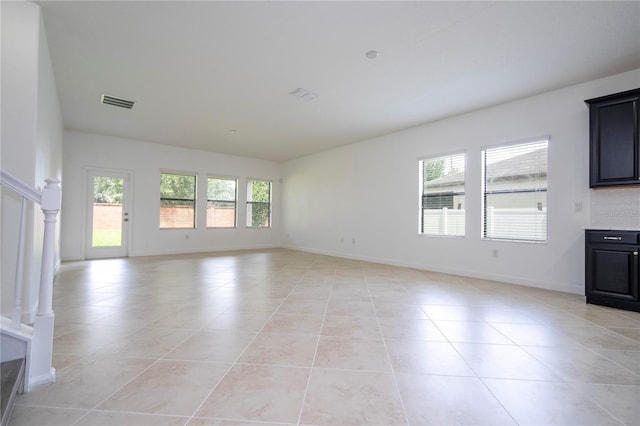 unfurnished living room with light tile patterned floors