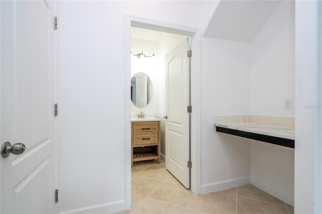 bathroom with tile patterned flooring and vanity