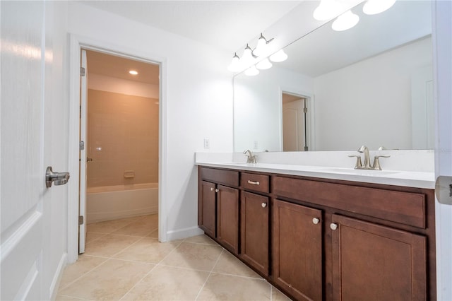 bathroom featuring tile patterned flooring, vanity, and tiled shower / bath