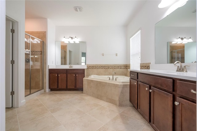 bathroom with tile patterned floors, vanity, and shower with separate bathtub