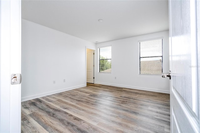 spare room with light hardwood / wood-style floors