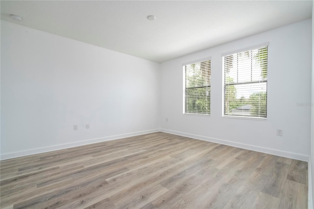 spare room with light hardwood / wood-style floors