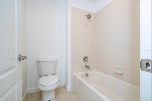 bathroom with tile patterned floors, toilet, and tiled shower / bath