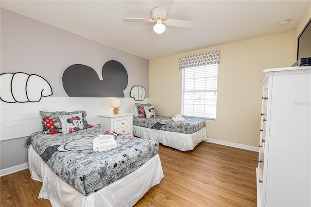 bedroom with ceiling fan and light hardwood / wood-style flooring