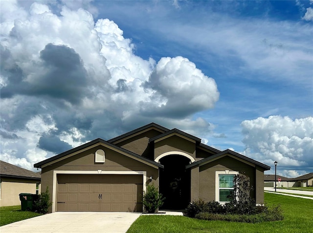 view of front of house with a garage and a front lawn