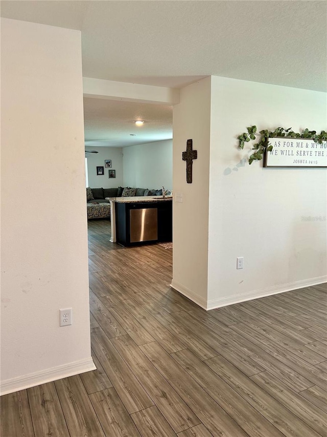 unfurnished room with dark hardwood / wood-style floors and a textured ceiling