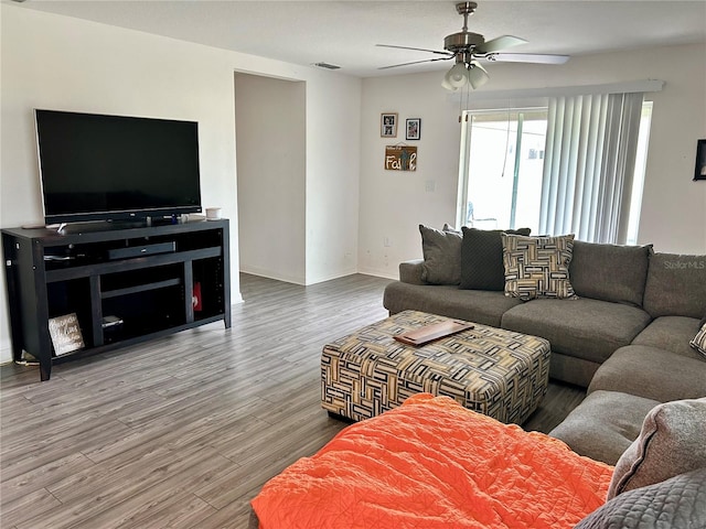 living room with ceiling fan and hardwood / wood-style flooring