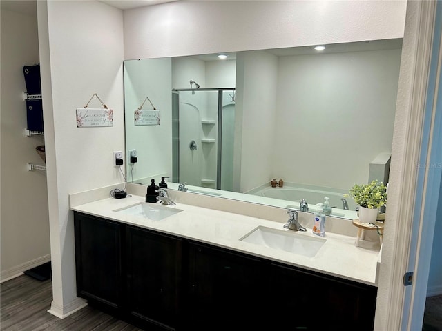 bathroom with vanity, separate shower and tub, and hardwood / wood-style flooring