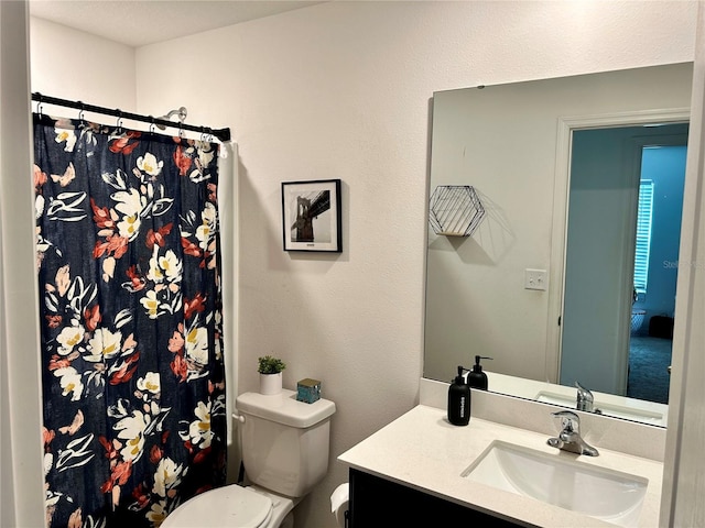 bathroom with vanity, toilet, and curtained shower