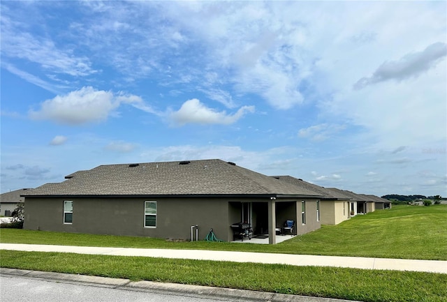 exterior space with a lawn and a patio