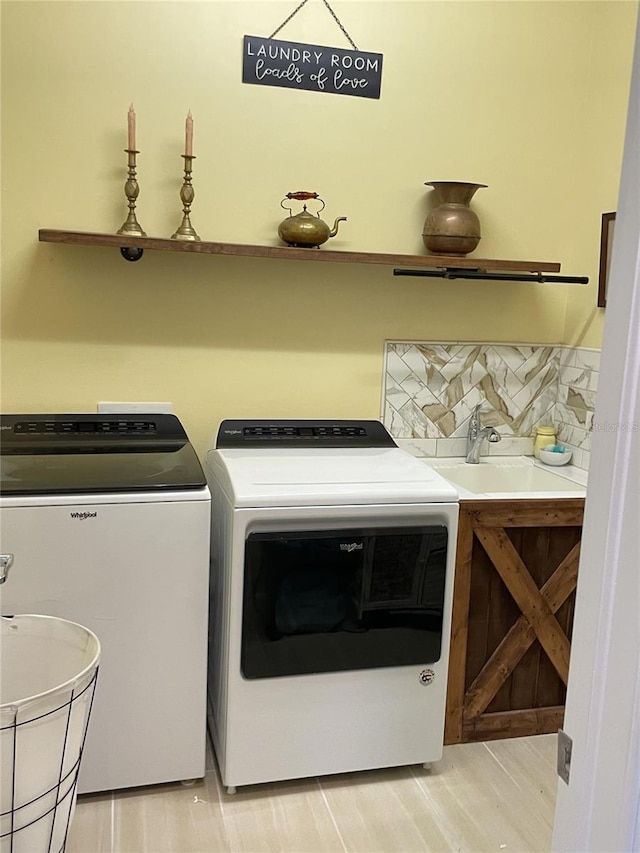 laundry room with washing machine and dryer and sink