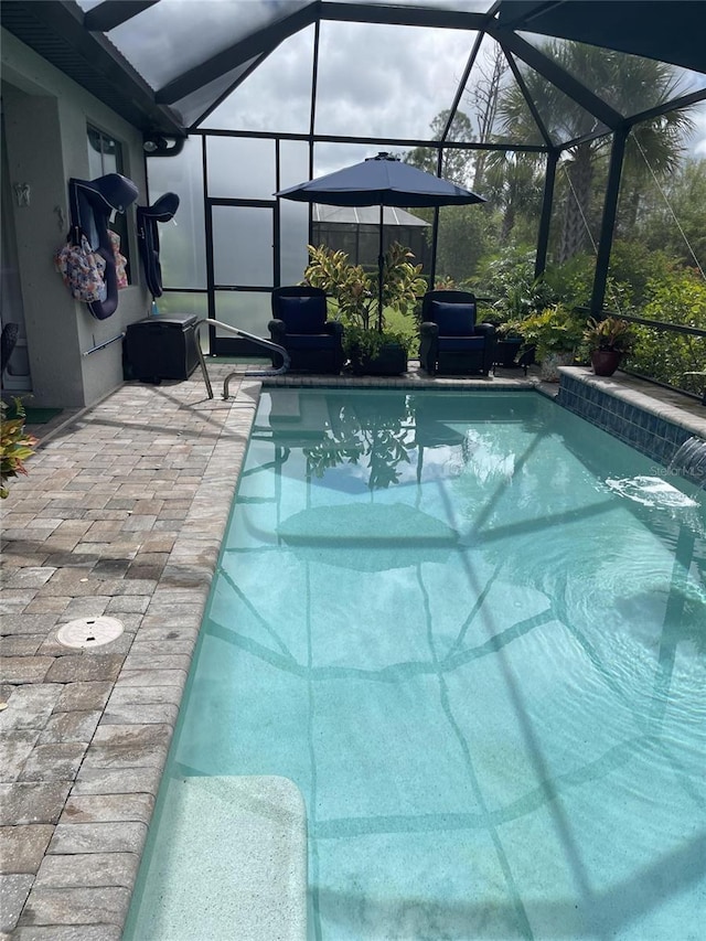 pool featuring a lanai and a patio area