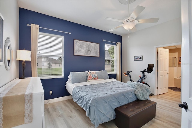 bedroom featuring ensuite bath, light hardwood / wood-style floors, and ceiling fan