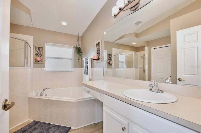 bathroom featuring plus walk in shower, lofted ceiling, vanity, and tile patterned floors