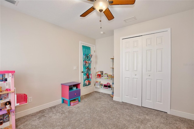 playroom with light carpet and ceiling fan