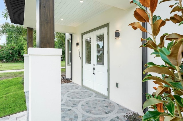 property entrance with french doors and a yard