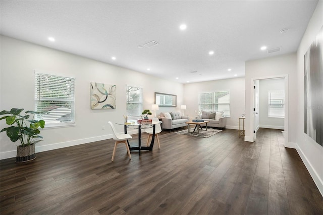 sitting room featuring a textured ceiling and dark hardwood / wood-style floors