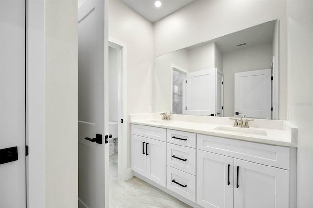 bathroom featuring vanity and toilet