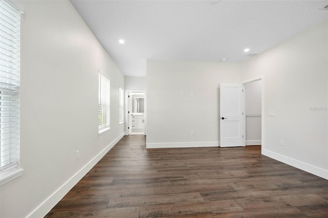 empty room with dark hardwood / wood-style floors