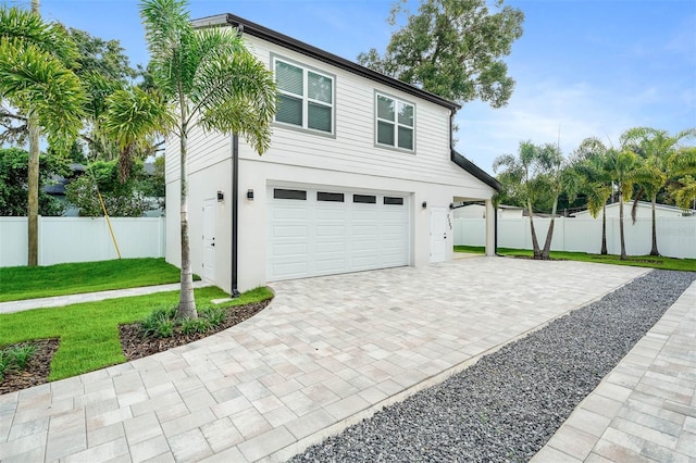 exterior space featuring a front lawn and a garage