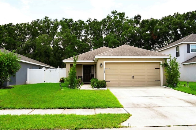 view of front of home with a front lawn and a garage