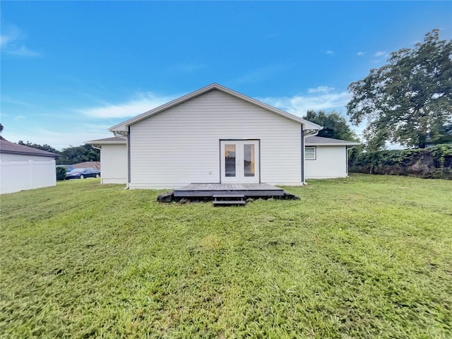 back of house with a lawn and a wooden deck